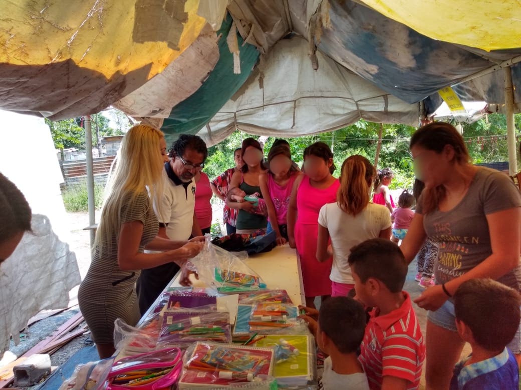 Smiling student receiving uniforms and packages